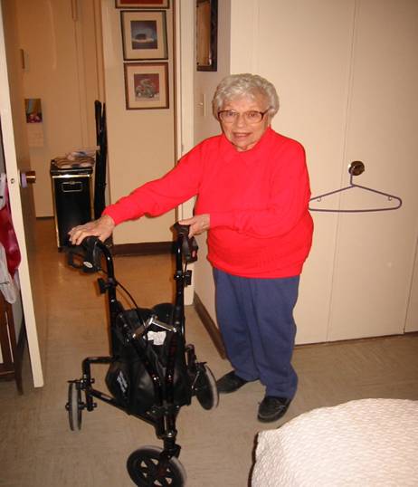Photo of smiling senior woman with wheeled walking aid