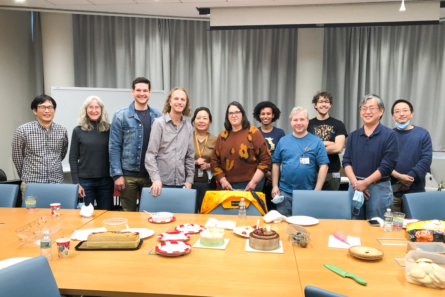Members of the Wang Lab Celebrate with Cake in a Conference Room