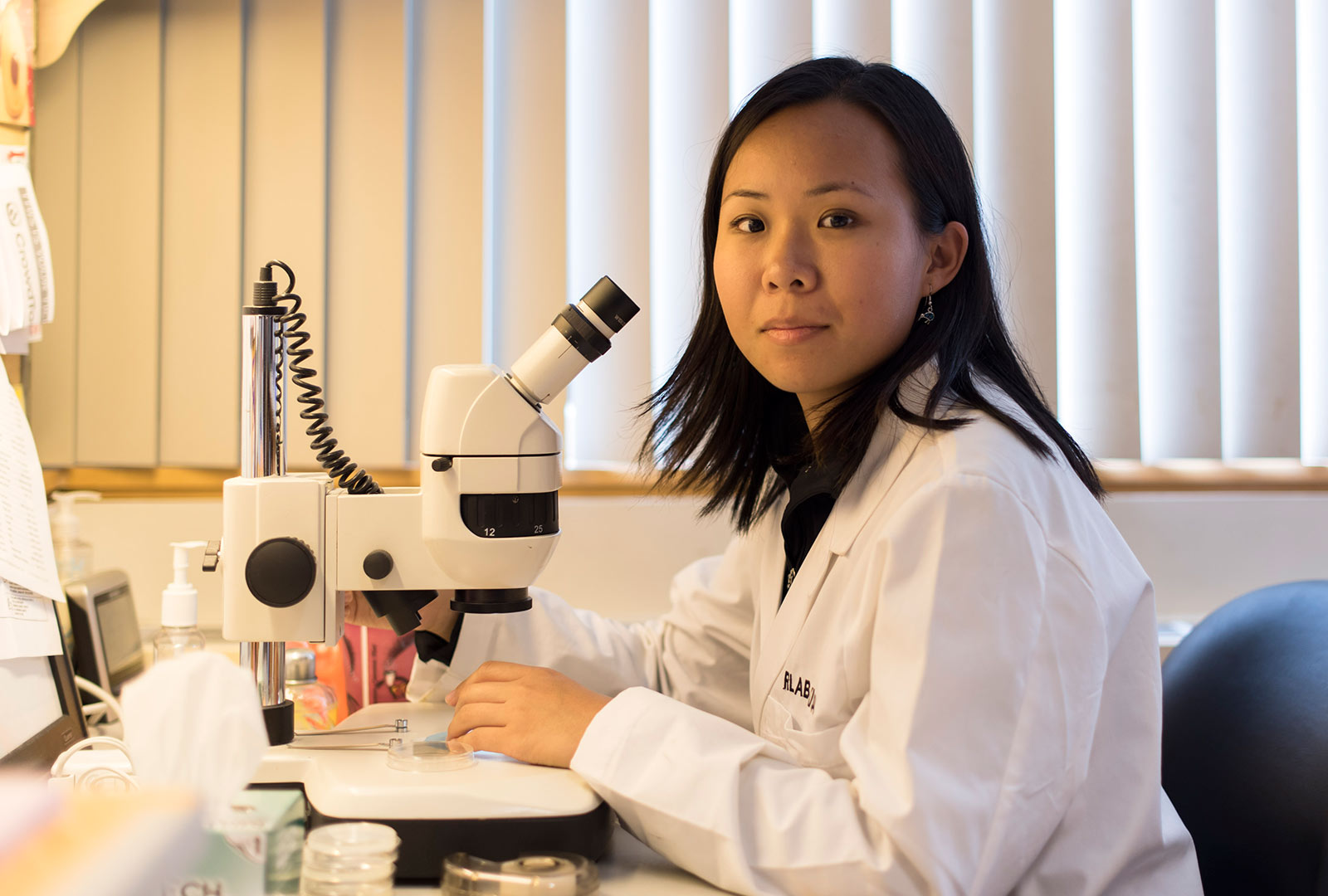 MD/PhD Candidate Alice Fok with Microscope