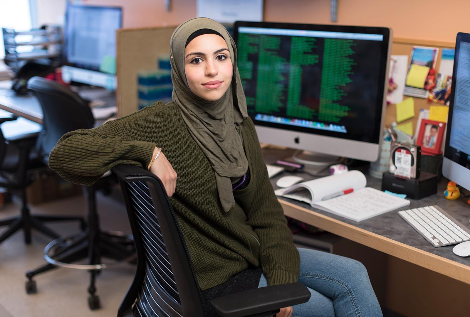 PhD Candidate Sana Badri Sitting in Front of Computer